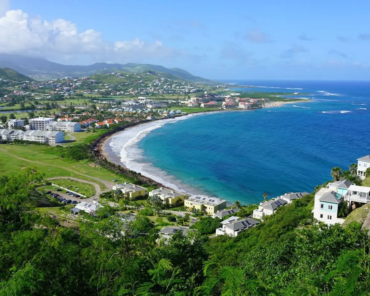 Frigate Bay on St Kitts, green hills meeting the Atlantic